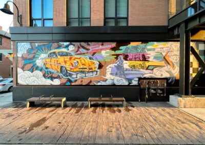 A 1953 Chrysler Checker Cab in a futuristic setting is the design backbone of our urban art wall on the Robertson Building.